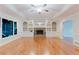 Bright living room featuring built-in shelving, stone fireplace and hardwood floors at 2552 Berwick Walk, Snellville, GA 30078