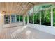 Relaxing screened-in porch overlooking a peaceful backyard filled with lush trees and plants at 2552 Berwick Walk, Snellville, GA 30078