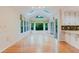 Bright sunroom boasts plentiful windows, vaulted ceilings with skylights, hardwood floors, and a serene view at 2552 Berwick Walk, Snellville, GA 30078