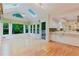 Sunroom off kitchen offers natural lighting, hardwood floors, views of treeline, and door to deck at 2552 Berwick Walk, Snellville, GA 30078