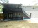 Two-story house boasts a spacious deck, complemented by a staircase and gray siding at 2845 Woodhollow Ln, Jonesboro, GA 30236