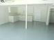 Clean basement features an epoxy floor, storage cabinets, and bright lighting at 2845 Woodhollow Ln, Jonesboro, GA 30236
