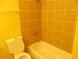 Bathroom featuring tile walls, bathtub, and showerhead at 2845 Woodhollow Ln, Jonesboro, GA 30236