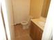 Bathroom featuring wood vanity, sink, tile floors, and toilet at 2845 Woodhollow Ln, Jonesboro, GA 30236
