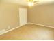 Spacious bedroom featuring a ceiling fan, neutral-toned walls, plush carpet, and a practical closet space at 2845 Woodhollow Ln, Jonesboro, GA 30236