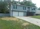 Well-maintained gray home with a two-car garage and a neat front yard at 2845 Woodhollow Ln, Jonesboro, GA 30236