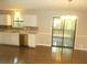 Well-lit kitchen with stainless steel appliances, white cabinets and a sliding glass door at 2845 Woodhollow Ln, Jonesboro, GA 30236