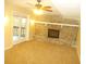 Living room with fireplace, carpet flooring, and glass doors at 2845 Woodhollow Ln, Jonesboro, GA 30236
