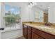 Bright bathroom with a granite double vanity and large window, creating an open and inviting space at 3700 Terrasol Sw Trl, Lilburn, GA 30047