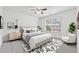 Bright bedroom featuring a ceiling fan, neutral walls, and a patterned rug, creating a cozy and inviting atmosphere at 3700 Terrasol Sw Trl, Lilburn, GA 30047