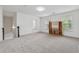 Open bonus room area with neutral carpet, built-in shelving, and great natural light at 3700 Terrasol Sw Trl, Lilburn, GA 30047