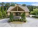 Charming clubhouse with stone accents, arched entryway, and a lush, manicured circular driveway at 3700 Terrasol Sw Trl, Lilburn, GA 30047