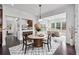 Bright dining area featuring modern decor, hardwood floors, flowing seamlessly into a living space with many windows at 3700 Terrasol Sw Trl, Lilburn, GA 30047