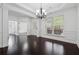 Spacious dining room with dark hardwood floors, white trim, and bright natural light at 3700 Terrasol Sw Trl, Lilburn, GA 30047