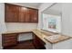 Home office with granite countertops, dark wood cabinets, and a view of the outdoors at 3700 Terrasol Sw Trl, Lilburn, GA 30047