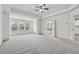 Open main bedroom with large windows providing natural light, trey ceilings, and neutral carpet at 3700 Terrasol Sw Trl, Lilburn, GA 30047