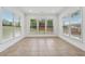 Bright sunroom with tile floors and large windows offering an abundance of natural light and outdoor views at 3700 Terrasol Sw Trl, Lilburn, GA 30047