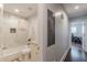 Well-lit bathroom featuring marble tile, modern fixtures and a tub with shower at 4324 Rocklane Dr, Conley, GA 30288