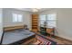 Cozy bedroom featuring hardwood floors, natural light, desk, and a comfortable bed at 4324 Rocklane Dr, Conley, GA 30288
