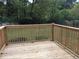 Wooden deck offers an outdoor living space with views of the lush, green backyard at 4324 Rocklane Dr, Conley, GA 30288
