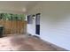 Covered patio area with white siding and privacy fence, perfect for outdoor relaxation at 4324 Rocklane Dr, Conley, GA 30288