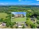 Stunning aerial view of the home with lush greenery and serene lake views highlighting the property's natural beauty at 592 Hayes Rd, Auburn, GA 30011