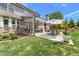 A lush backyard with a covered patio and dining set at 592 Hayes Rd, Auburn, GA 30011