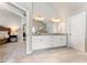 Elegant bathroom features double vanity, granite counters, tiled floors, and access to bedroom at 592 Hayes Rd, Auburn, GA 30011