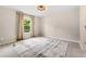 Spacious bedroom has a large window with outdoor views and neutral decor at 592 Hayes Rd, Auburn, GA 30011