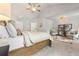 Well-lit bedroom suite features a seating area with furniture and decorations, vaulted ceilings, and neutral paint at 592 Hayes Rd, Auburn, GA 30011