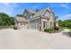 An attractive home featuring a well-manicured lawn, concrete driveway, and a three-car garage at 592 Hayes Rd, Auburn, GA 30011
