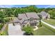 Elegant two-story home featuring a brick facade, manicured lawn, and inviting front porch at 592 Hayes Rd, Auburn, GA 30011