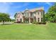 Elegant two-story home featuring a brick facade, manicured lawn, and inviting front porch at 592 Hayes Rd, Auburn, GA 30011