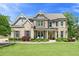 Charming two-story brick home with manicured landscaping and a welcoming front porch at 592 Hayes Rd, Auburn, GA 30011