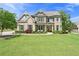Charming two-story home featuring a brick facade, manicured lawn, and inviting front porch at 592 Hayes Rd, Auburn, GA 30011
