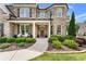 A beautiful home with a cozy front porch, manicured lawn, and elegant landscaping at 592 Hayes Rd, Auburn, GA 30011
