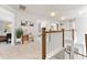 Bright hallway boasts natural light, neutral paint and carpet, wood banister, and access to multiple rooms at 592 Hayes Rd, Auburn, GA 30011
