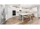 Bright kitchen featuring white cabinets, a large island, stainless steel appliances, and modern pendant lighting at 592 Hayes Rd, Auburn, GA 30011