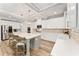 Bright, modern kitchen with white cabinetry, a large island, and stainless steel appliances at 592 Hayes Rd, Auburn, GA 30011