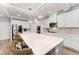 Spacious kitchen with a large center island, modern stainless appliances, and beautiful pendant lighting at 592 Hayes Rd, Auburn, GA 30011