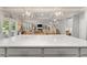 Kitchen island with white countertop, view to living room, and staircase leading upstairs at 592 Hayes Rd, Auburn, GA 30011