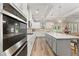 A gourmet kitchen with a large island, modern appliances, white cabinets, and stylish pendant lighting at 592 Hayes Rd, Auburn, GA 30011