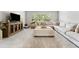 Inviting living room with a large comfortable sectional, media center, and oversized ottoman at 592 Hayes Rd, Auburn, GA 30011
