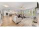 Spacious living room with a fireplace, large windows, and an open view into the kitchen at 592 Hayes Rd, Auburn, GA 30011