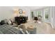 Bright living room featuring a decorative cabinet, comfortable seating, and large windows at 592 Hayes Rd, Auburn, GA 30011