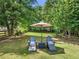 Lounge chairs on grass beneath shady trees at 592 Hayes Rd, Auburn, GA 30011