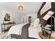 Comfortable main bedroom with accent wall, and light fixtures at 592 Hayes Rd, Auburn, GA 30011