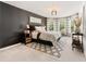 Well-lit main bedroom featuring an area rug, and bright windows at 592 Hayes Rd, Auburn, GA 30011