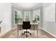 Brightly lit home office space with three windows, desk, and hardwood floors at 592 Hayes Rd, Auburn, GA 30011