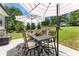 Outdoor dining set with umbrella and manicured garden at 592 Hayes Rd, Auburn, GA 30011